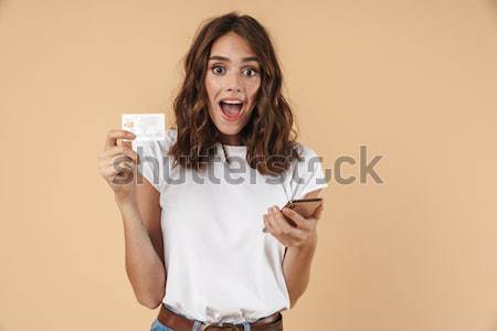 Astonished african businesswoman covered half face with blank paper sheets Stock photo © deandrobot