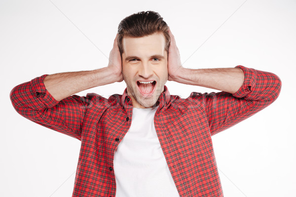 Screaming man covering his ears Stock photo © deandrobot