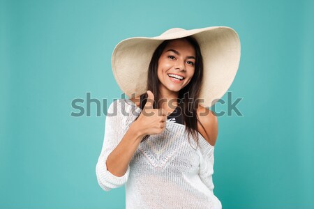 Happy pretty young woman in hat standing and holding pineapple Stock photo © deandrobot