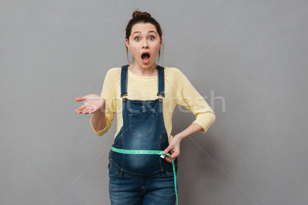 Zwangere geschokt vrouw centimeter afbeelding permanente Stockfoto © deandrobot