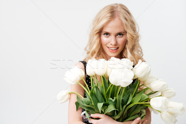 Csinos szőke nő pózol virágcsokor virágok néz Stock fotó © deandrobot