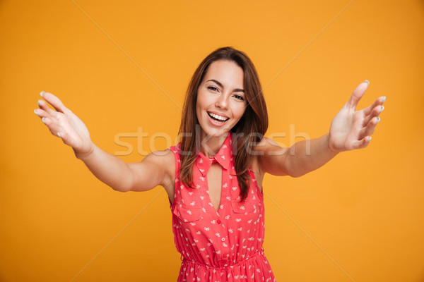 Close-up portrait of attractive young woman stretching her arms, Stock photo © deandrobot