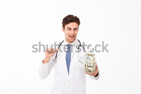 Portrait of a smiling happy male doctor Stock photo © deandrobot