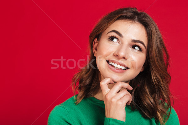 Smiling dreaming young pretty woman standing isolated Stock photo © deandrobot