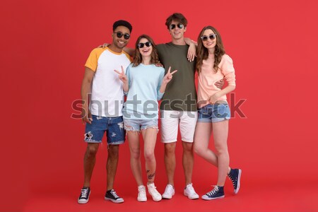 Portrait of a young cheerful multiracial group of friends Stock photo © deandrobot