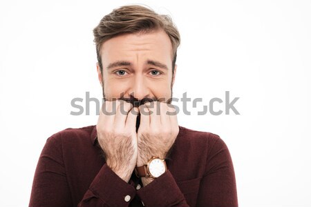 Scared young man covering mouth with hands Stock photo © deandrobot