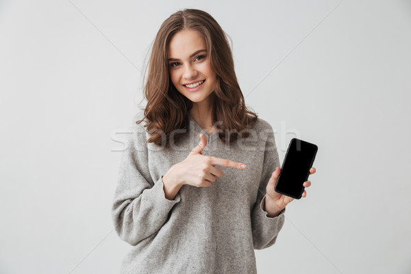 Sorridere bruna donna maglione smartphone Foto d'archivio © deandrobot