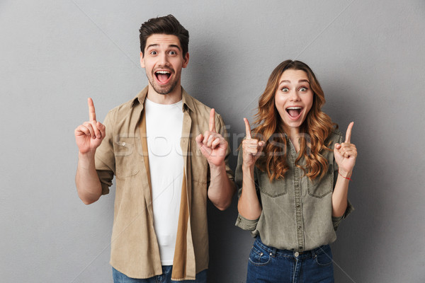 Portrait of a cheerful young couple standing together Stock photo © deandrobot