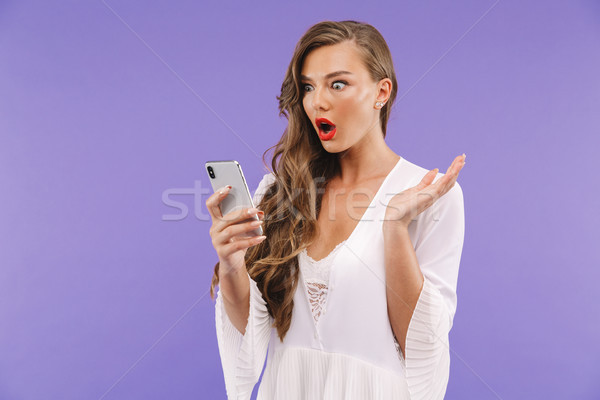 Photo of shocked european woman 20s with long curly hairstyle we Stock photo © deandrobot