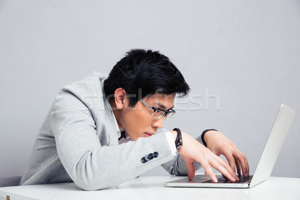 Businessman using laptop in office Stock photo © deandrobot