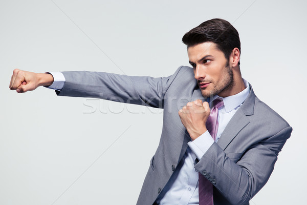 Businessman punching  Stock photo © deandrobot