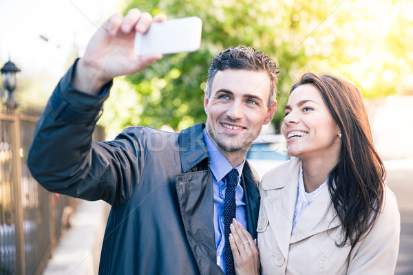 Woman and man making selfie photo outdoors Stock photo © deandrobot