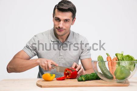 Happy man preparing salad Stock photo © deandrobot