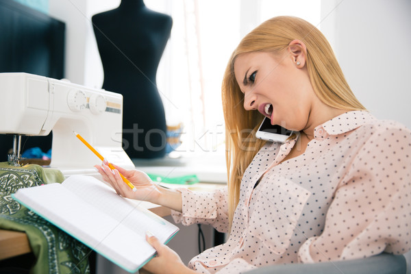 Designer talking on the phone with disgust emotion Stock photo © deandrobot