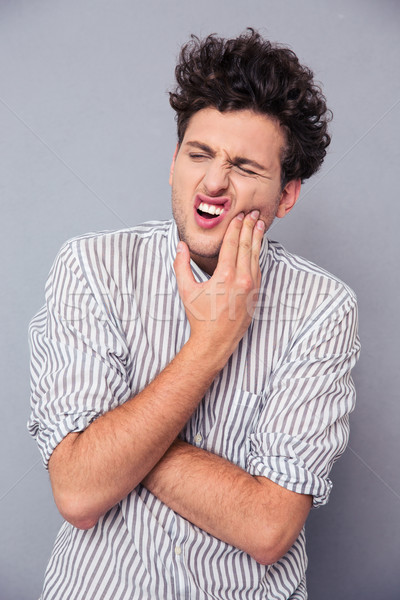 Man having toothy pain Stock photo © deandrobot