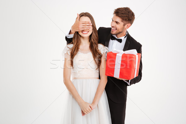 Csinos ifjú pár ajándék férfi csukott szemmel lány Stock fotó © deandrobot