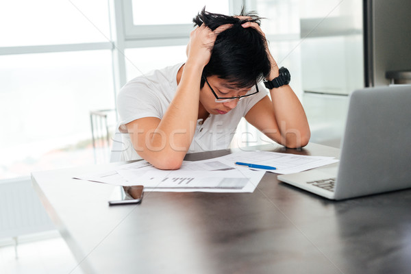 Asian man in panic by the table Stock photo © deandrobot