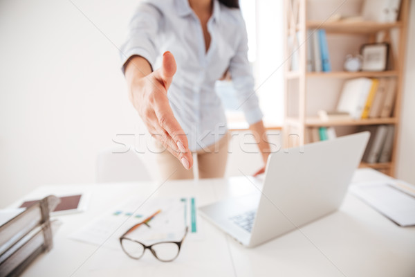 Stock photo: Businesswoman making handshake gesture to the camera