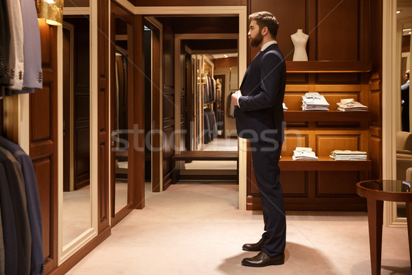 Side view of man tries on a suit Stock photo © deandrobot