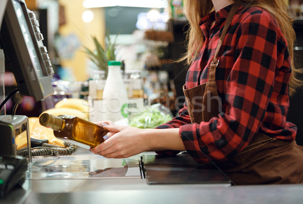 Cashier lady on workspace in supermarket shop. Stock photo © deandrobot
