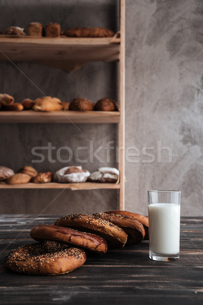 Pastries and glass of milk on dark wooden table Stock photo © deandrobot