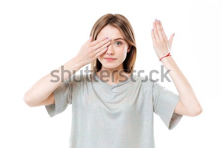Young cute girl covering eyes Stock photo © deandrobot