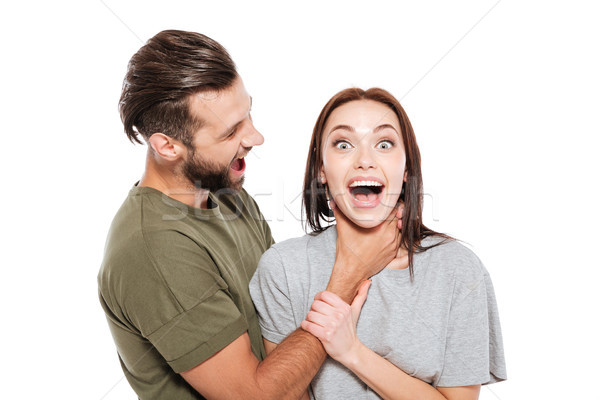 Happy young loving couple standing isolated Stock photo © deandrobot