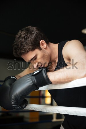 Boxer training in a boxing ring. Looking aside. Stock photo © deandrobot
