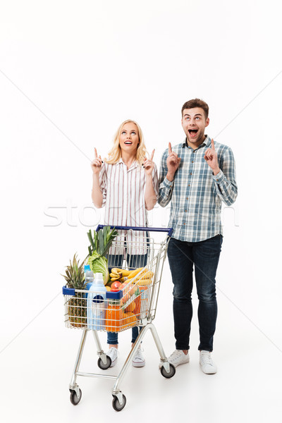 Full length portrait of a cheerful couple Stock photo © deandrobot