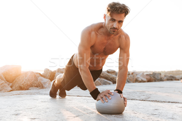 Portrait of a handsome shirtless sportsman Stock photo © deandrobot