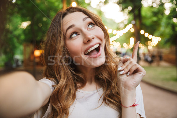 Close up of dreamy young girl taking a selfie Stock photo © deandrobot