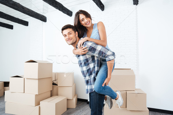 Young couple moving in new house Stock photo © deandrobot