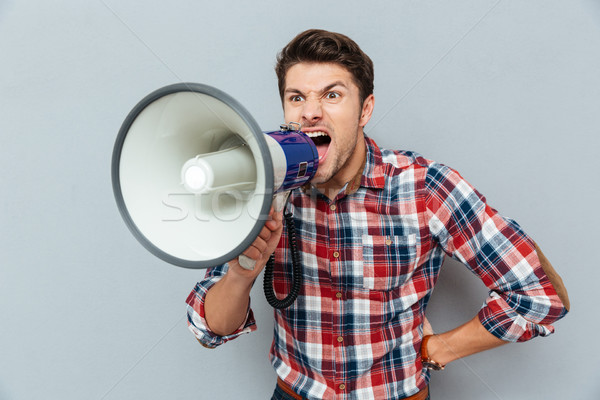Furieux agressif jeune homme permanent haut-parleur Photo stock © deandrobot