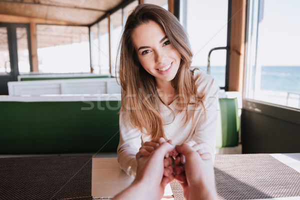 Smiling woman on date in cafe near the sea Stock photo © deandrobot