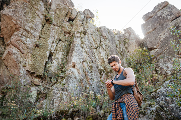 Stock photo: Traveling man looking at wristwatch