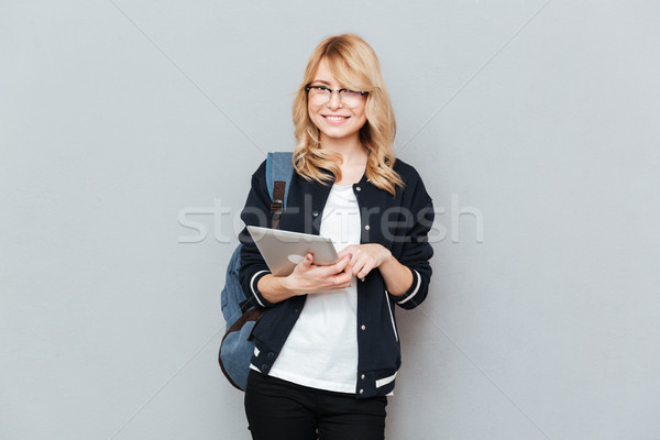 Student looking camera while using tablet Stock photo © deandrobot