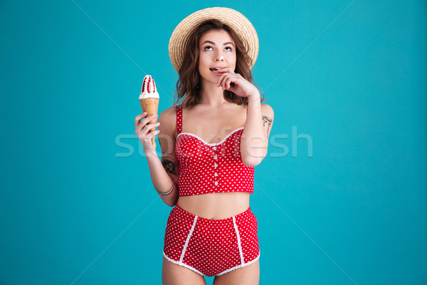 Thinking young woman with ice-cream and opened mouth Stock photo © deandrobot