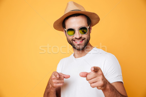 Cheerful young man standing isolated over yellow background Stock photo © deandrobot