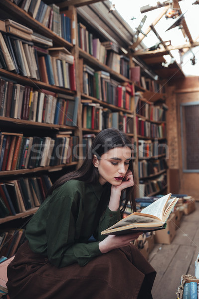 Pretty girl reading book in library Stock photo © deandrobot