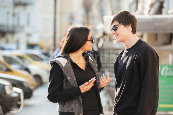 Woman walking outdoors with her brother. Stock photo © deandrobot