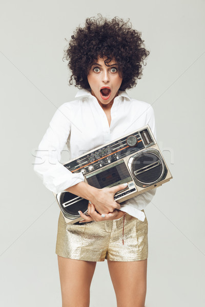Shocked retro woman holding boombox. Stock photo © deandrobot