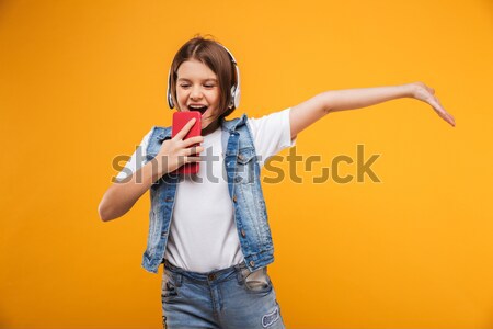 Portrait of a cheerful pretty woman dressed in denim jacket Stock photo © deandrobot
