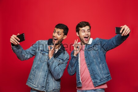 Man standing with soda while covering eyes to his girl Stock photo © deandrobot