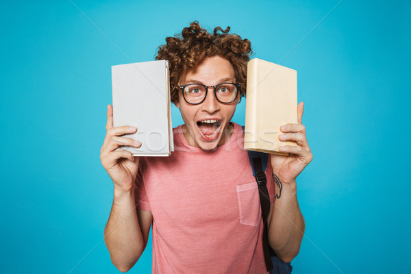 Image of genius student guy with curly hair wearing glasses and  Stock photo © deandrobot