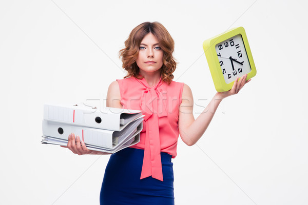 Businesswoman holding folder and clock Stock photo © deandrobot