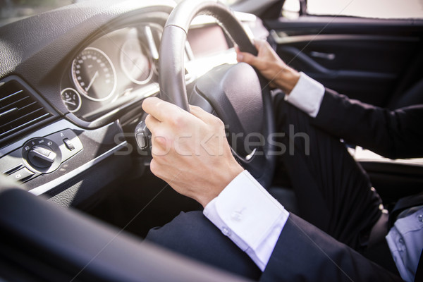 Male hands driving car Stock photo © deandrobot