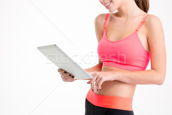 Tablet benutzt schlank schönen jungen Sportlerin Stock foto © deandrobot
