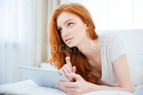 Redhead woman thinking about something Stock photo © deandrobot