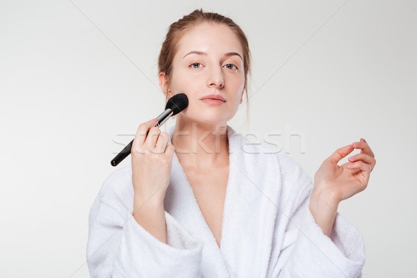 Stock photo: Cute woman with cosmetic brush