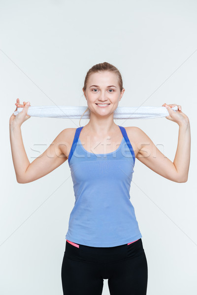 Happy fitness woman holding towel Stock photo © deandrobot